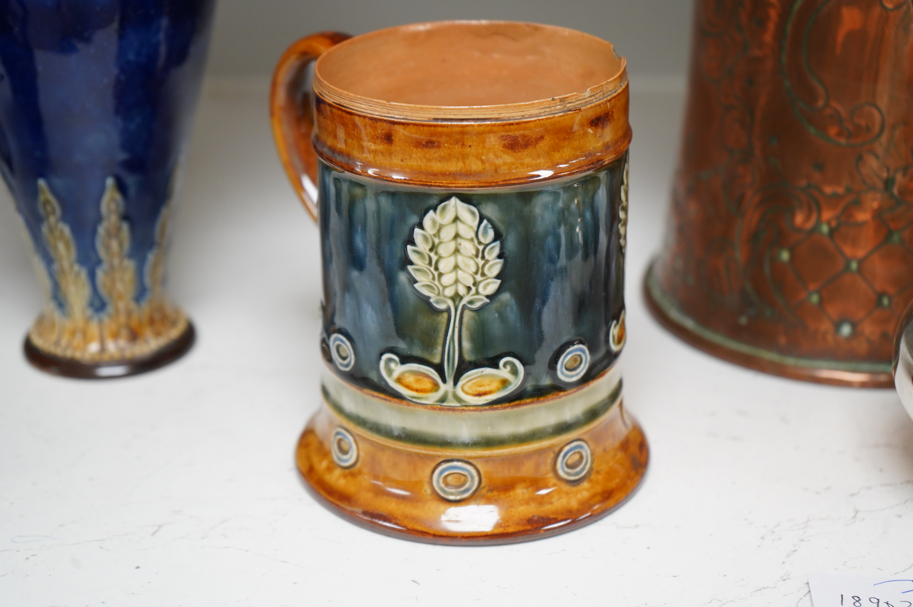 A Doulton Lambeth stoneware commemorative pitcher of William Ewart Gladstone 23cm high, together with a pair of vases two handled vase and a mug, (5).